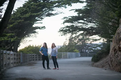 Emma & Julie standing on the path at Land's End looking in different directions from each other